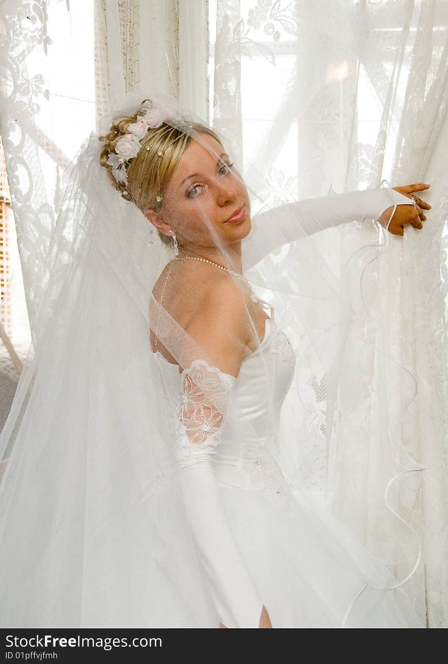 Beautiful Young Fiancee Near A Window .