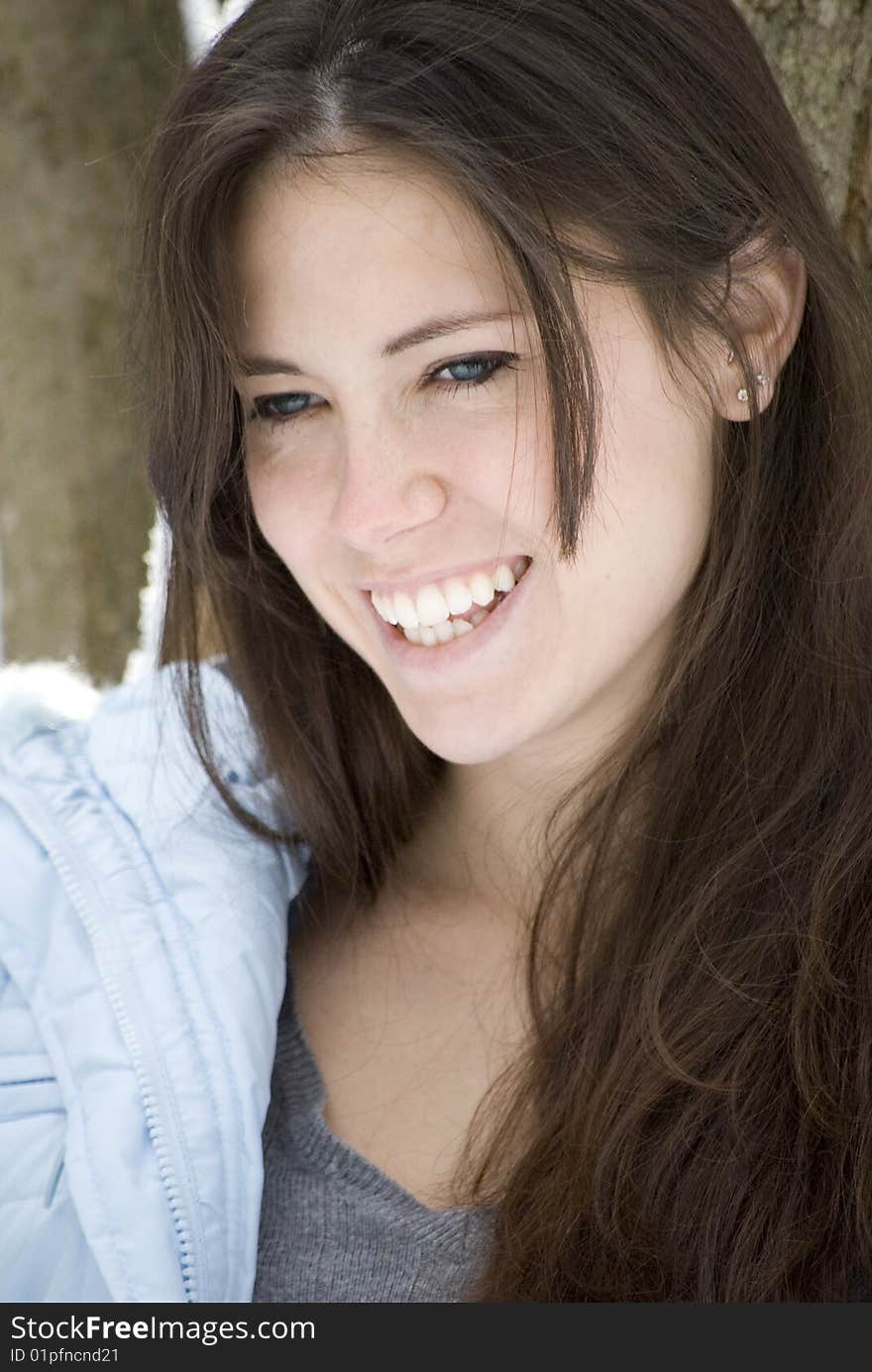 Pretty young woman smiling outdoors. Pretty young woman smiling outdoors