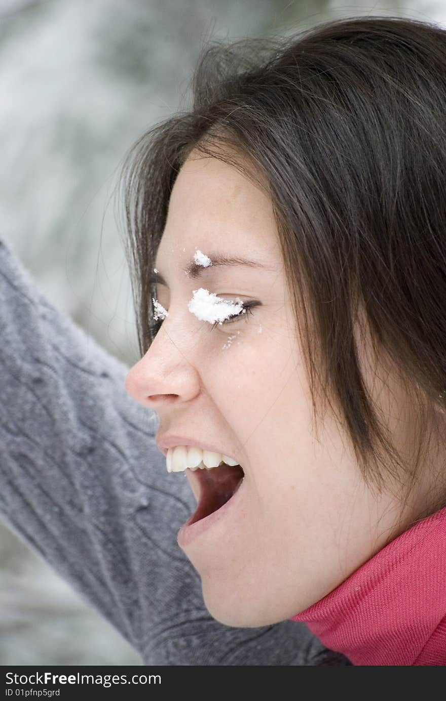 Pretty young woman with snow on face. Pretty young woman with snow on face