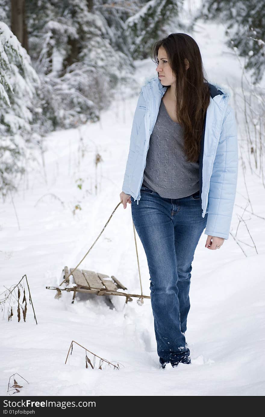 Beautiful woman pulling sled