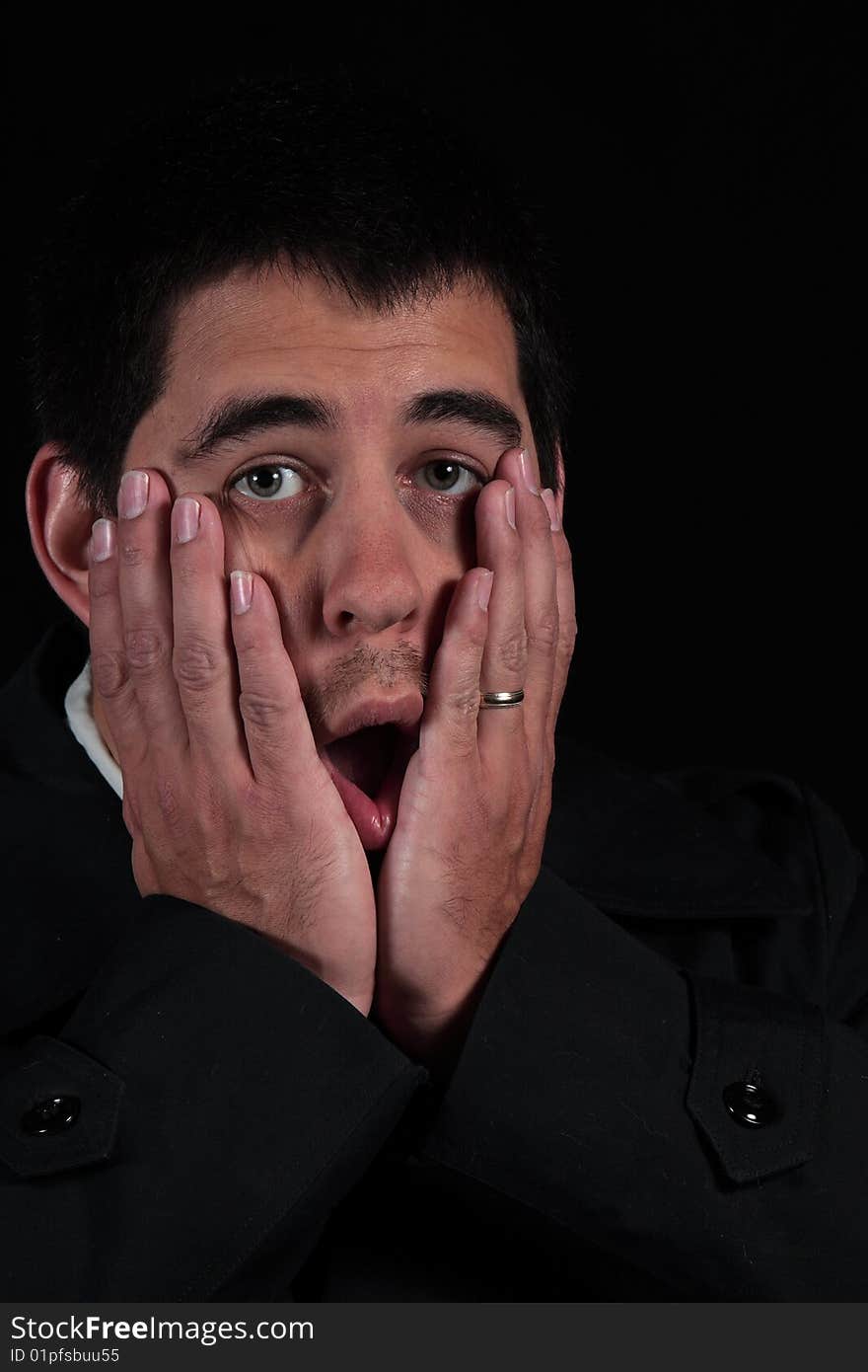 Surprised male portrait isolated on black background