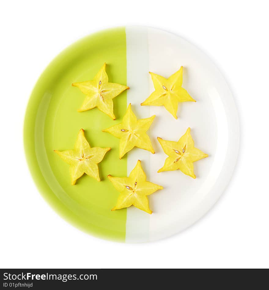 Slices of starfruit (carambola) on a two-colored plate. Slices of starfruit (carambola) on a two-colored plate