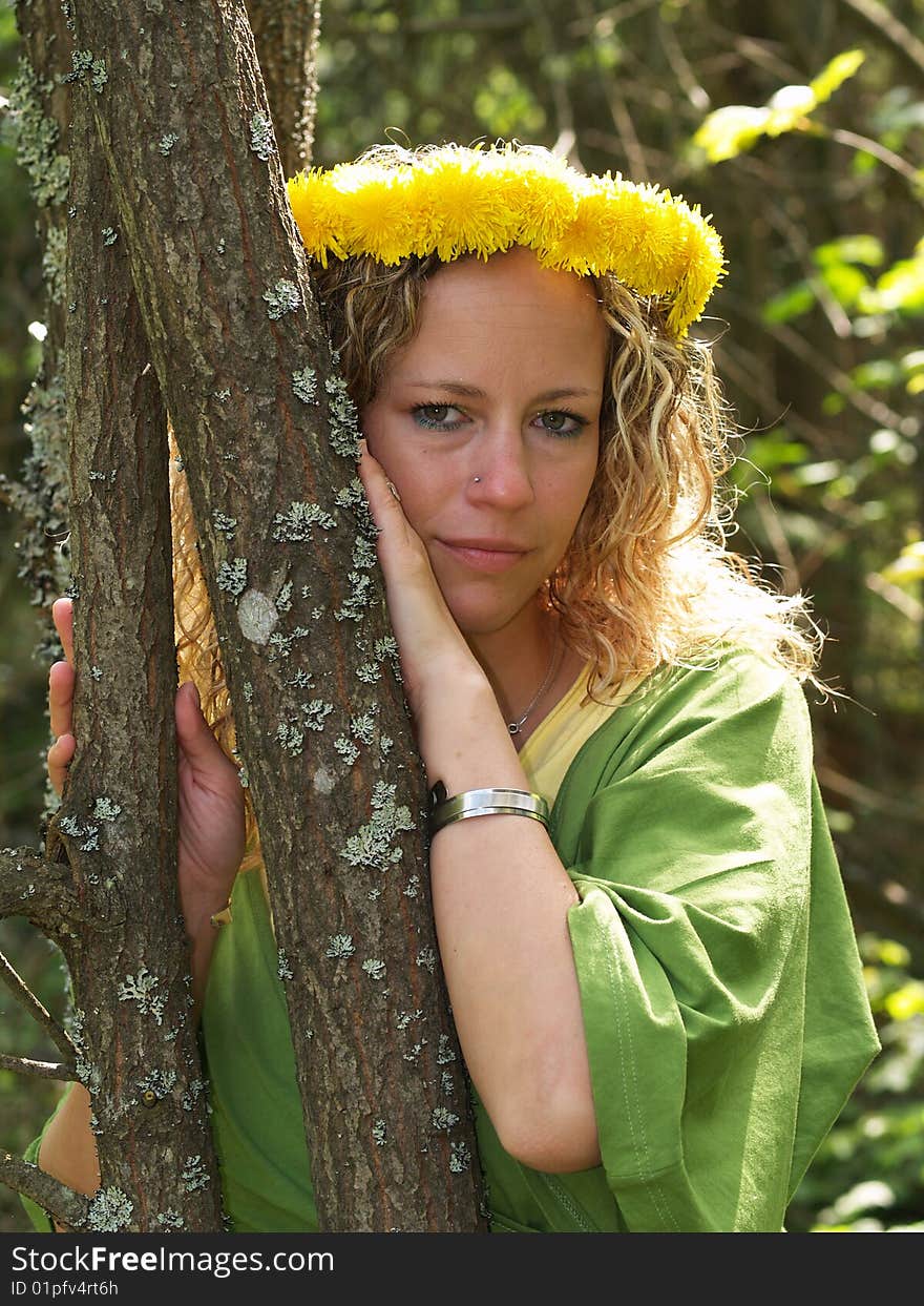 Curly girl with dandelion chain