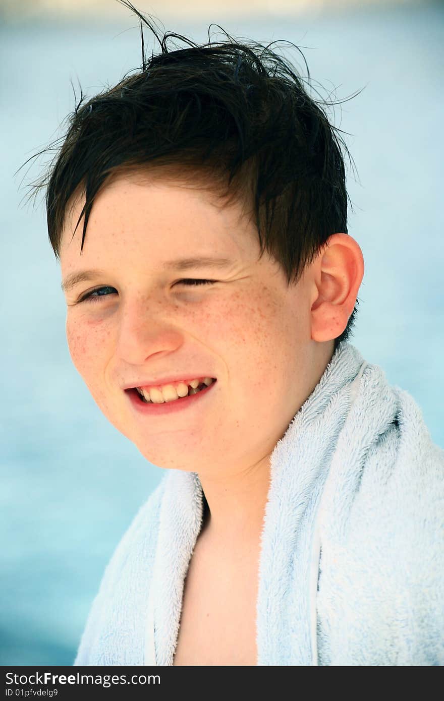 Smiling boy in beach towel