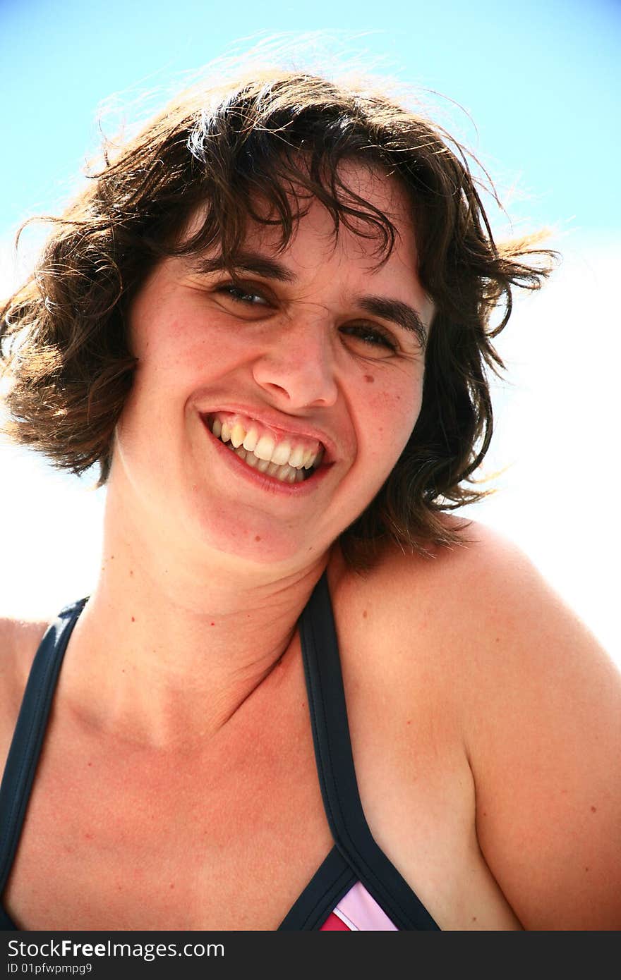 Woman smiling in swimsuit at the beach