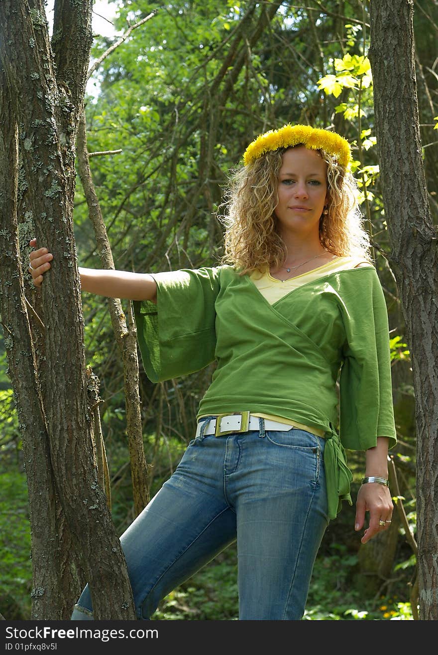 Curly girl with dandelion chain