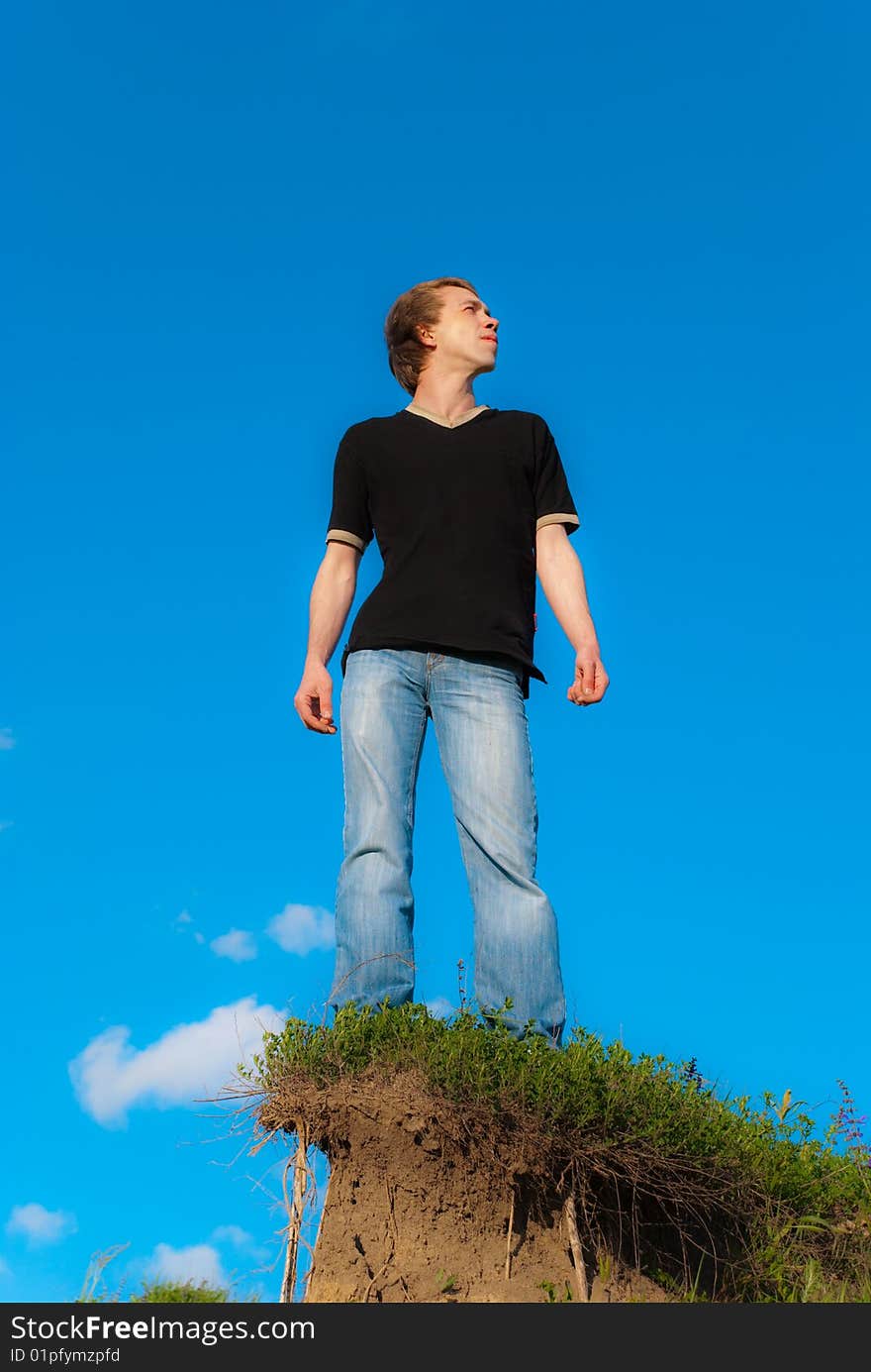 Man standing on a hill at the spring daytime. Man standing on a hill at the spring daytime