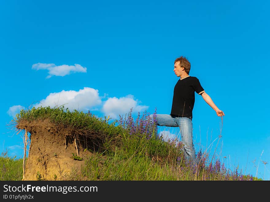 Man going on a hill sprading hands. Man going on a hill sprading hands