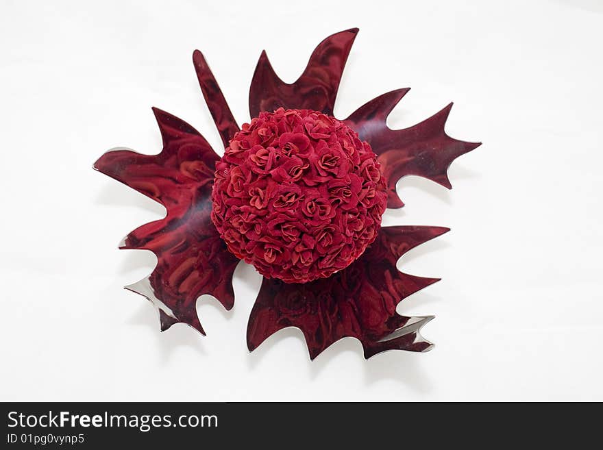 A ball of red flowers on a silver plate