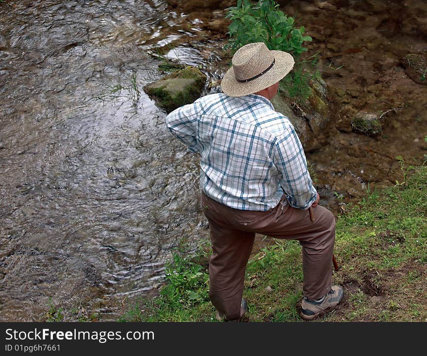 Sixty year old man watching the river. Sixty year old man watching the river