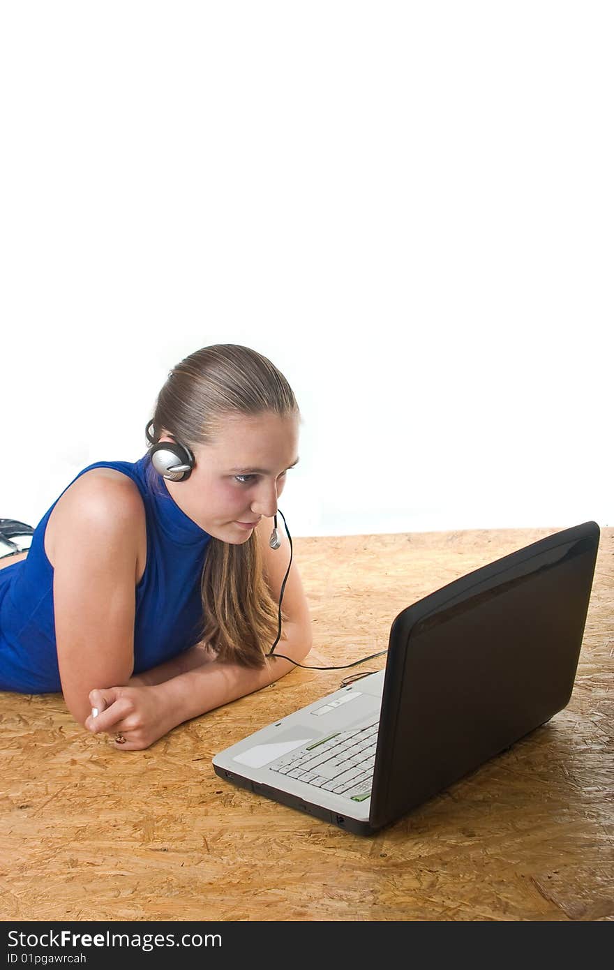 Teenage girl lying on the floor with laptop,isolated over white background. Teenage girl lying on the floor with laptop,isolated over white background