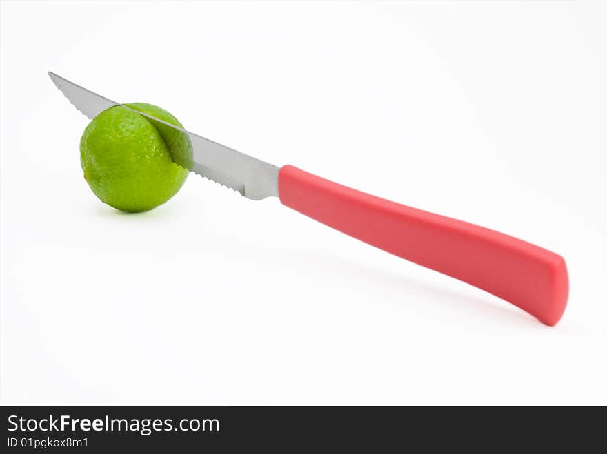 Limes being cut by red knife