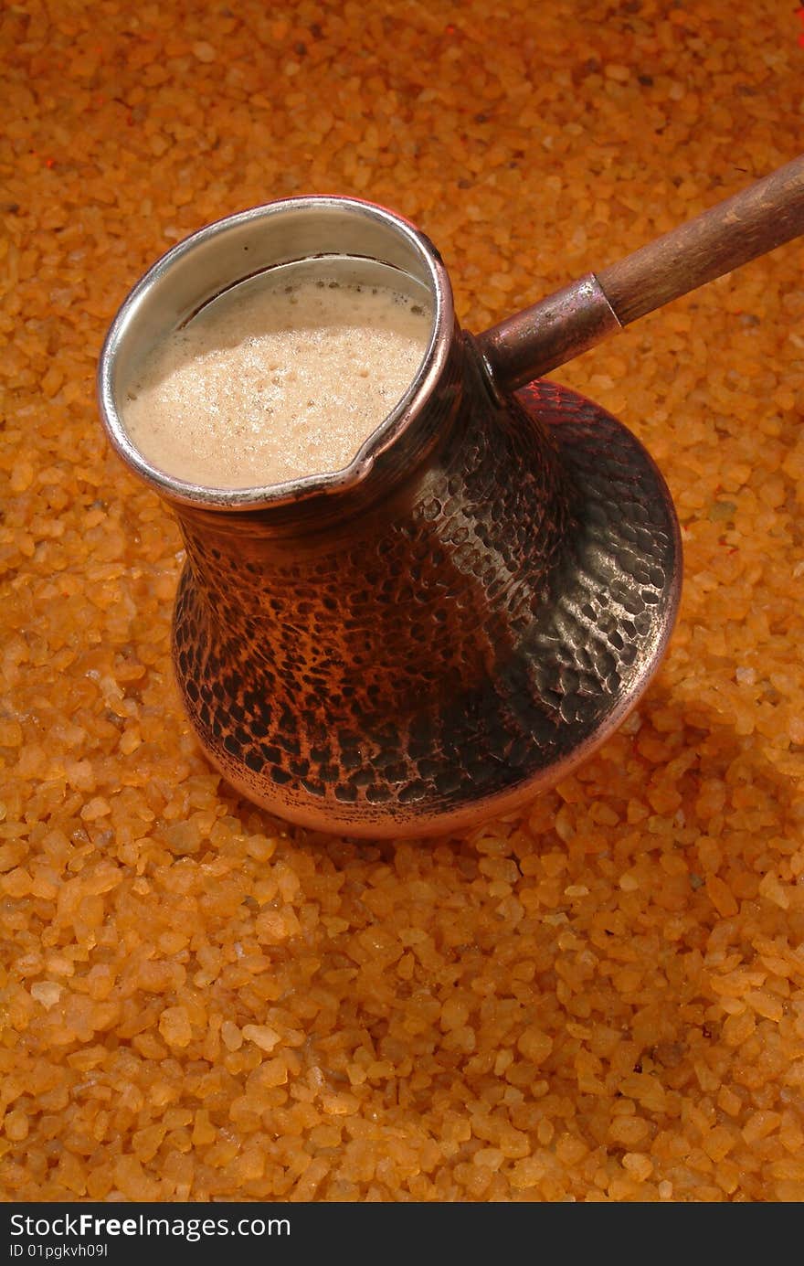 Coffee pot on the hot sand. Coffee pot on the hot sand