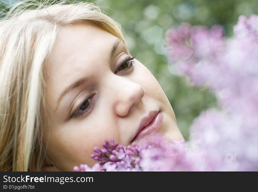 Portrait of a beauty young woman with lilac flowers