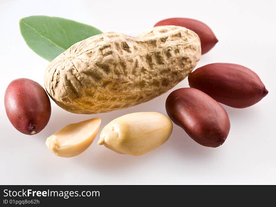 Peanut with pods and leaves on a white background.