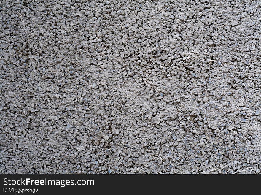 Concrete wall under a stone crumb