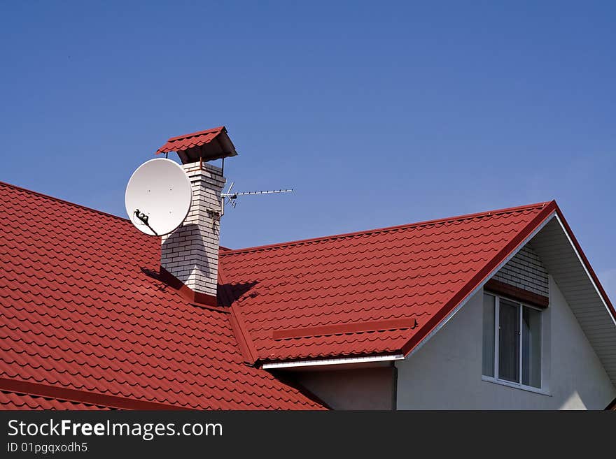 Roof from a tile on a background blue sky. Roof from a tile on a background blue sky