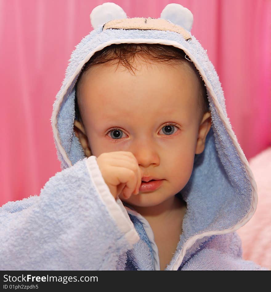 Little boy dressed in blue bathrobe