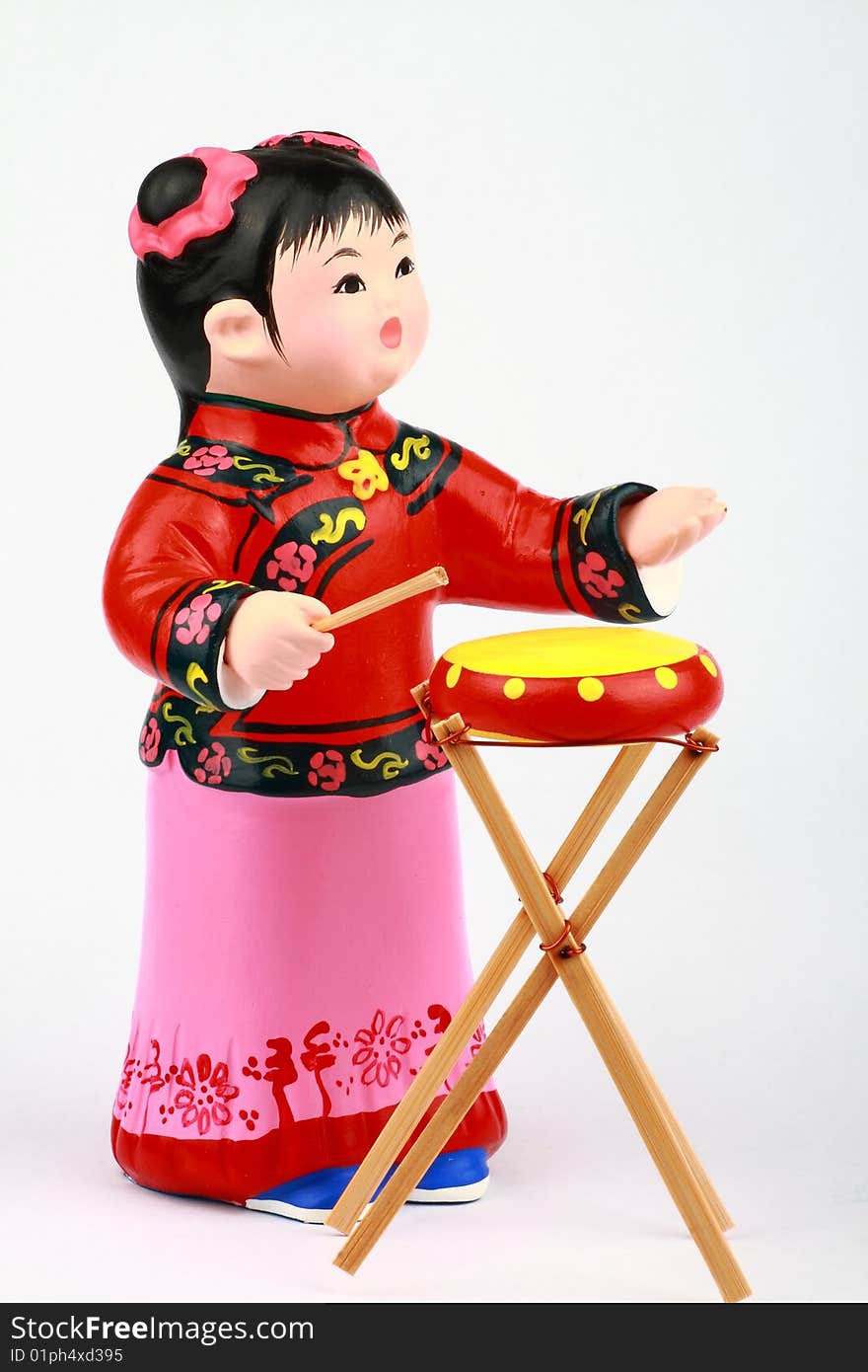 Clay Figure Of Asian Girl Playing Drum