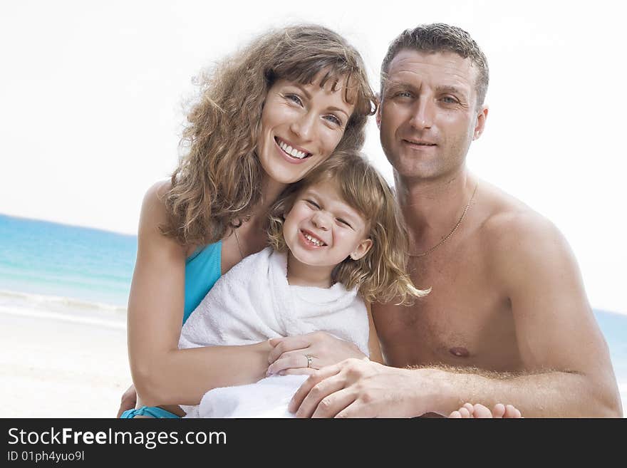 Portrait of young family having fun on the beach