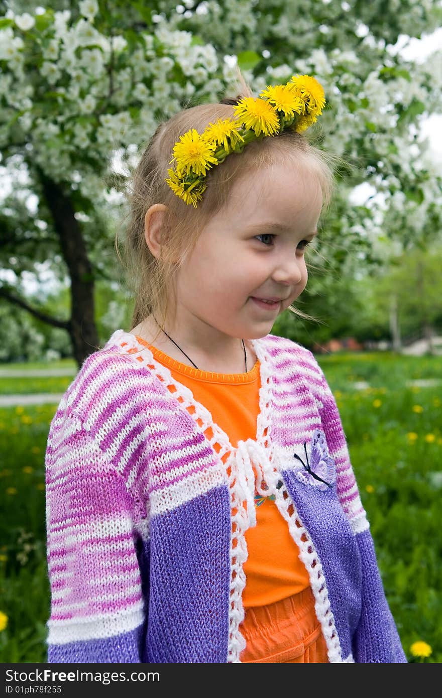 The girl and a wreath from dandelions 1