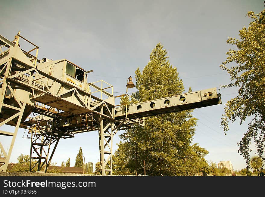 An old rusty crane standing outside