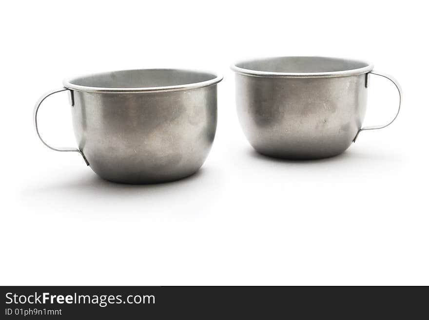 Two tinware cups with eyes