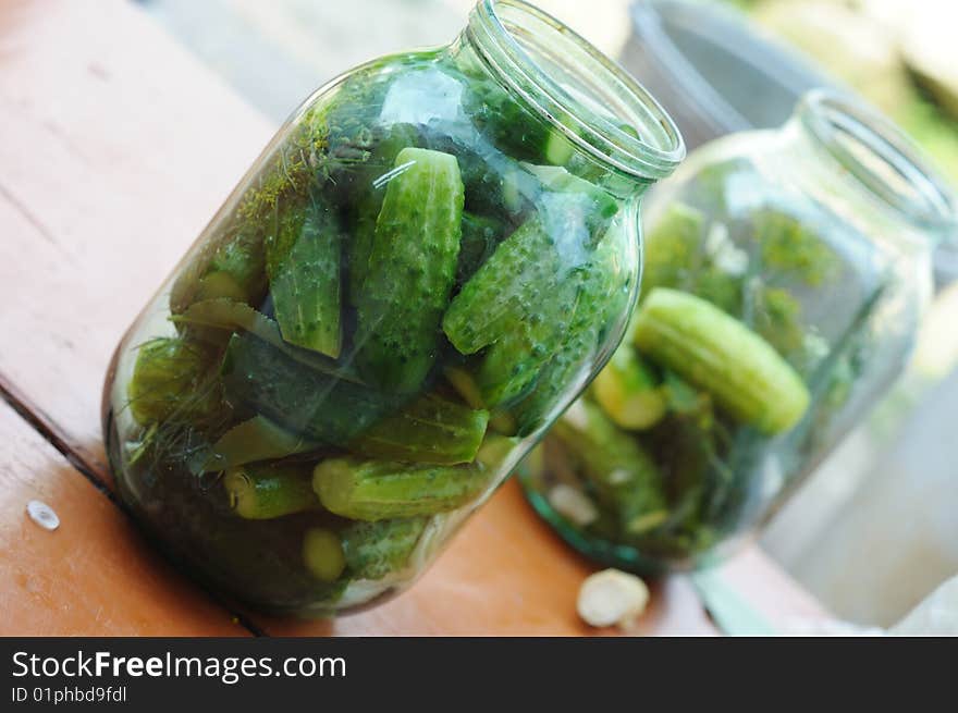 Glass jars with the cucumbers, prepared for conservation