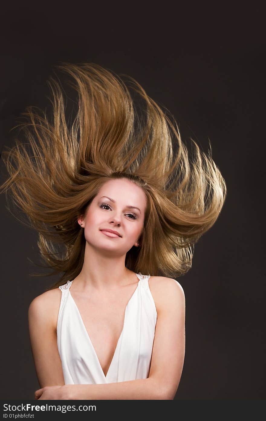 Happy young  girl with long flying hair