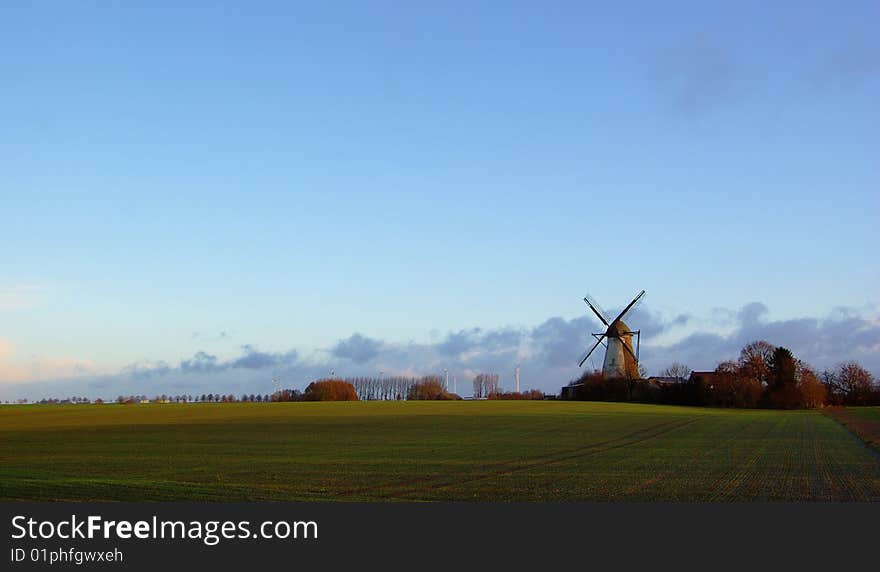 Morning light, traditional windmilland modern windmill generators