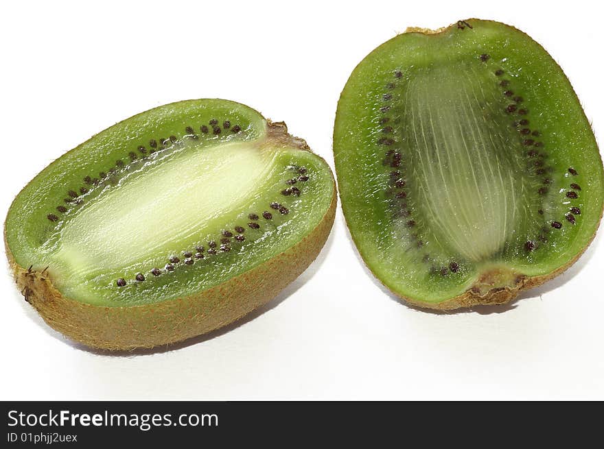 The fruit is cut on two parts on a white background. The fruit is cut on two parts on a white background