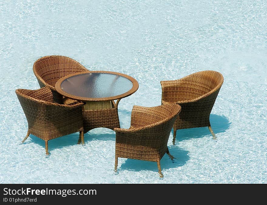 Restaurant on water, wicker chairs and glass tables