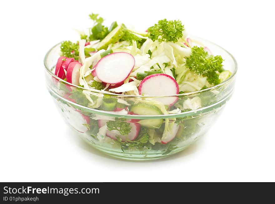 Vegetable salad in glass plate on white background