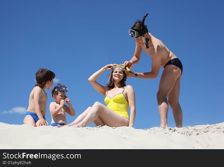 Family of four going to swim with snorkeling masks. Family of four going to swim with snorkeling masks