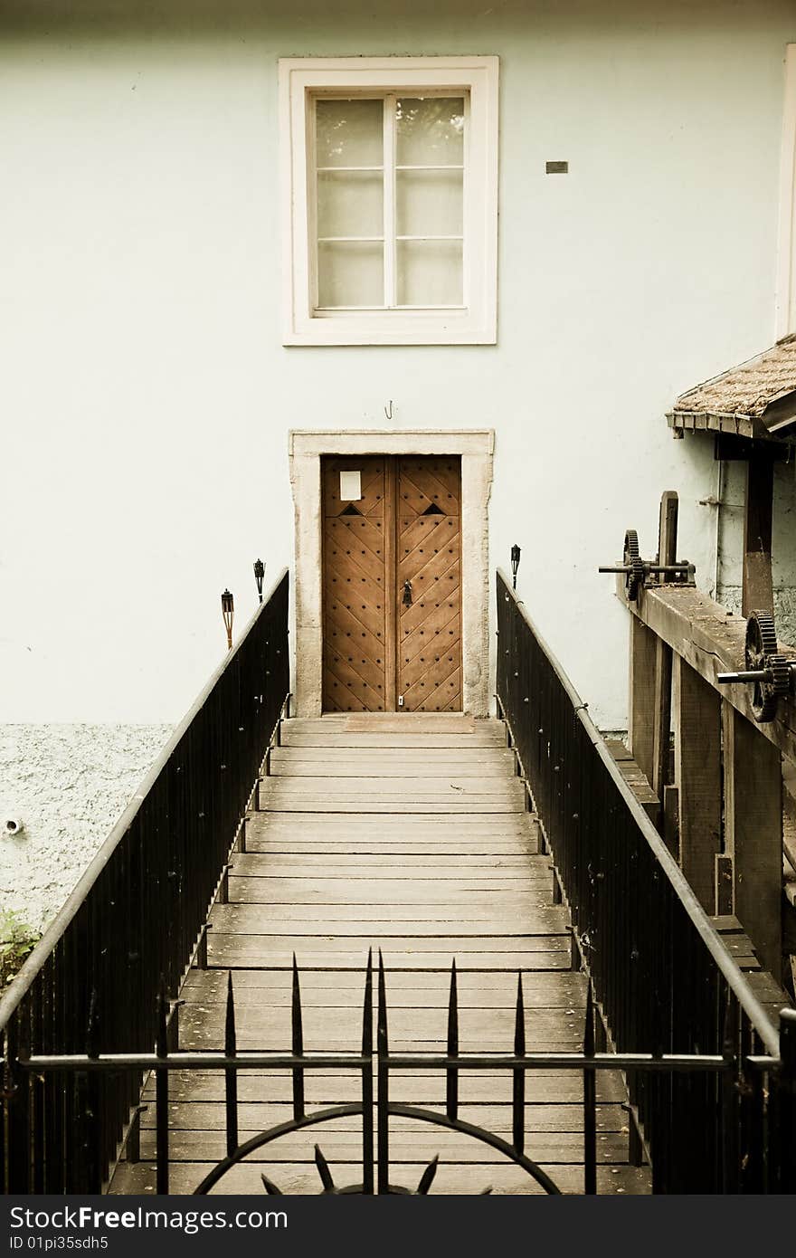 Closed door behind iron fence. Closed door behind iron fence