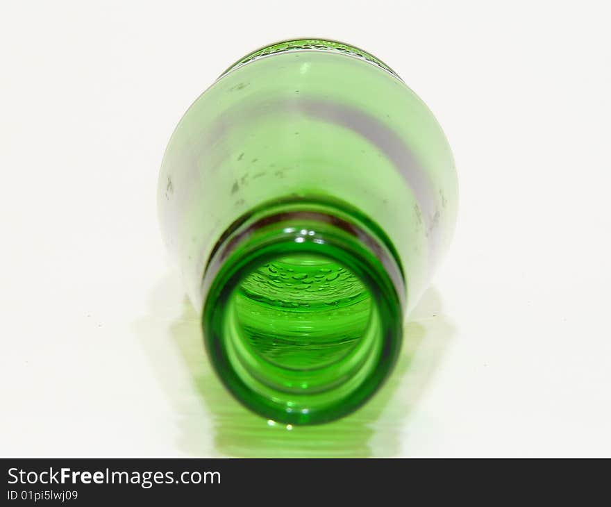 Green  bottle on side with white background. Green  bottle on side with white background