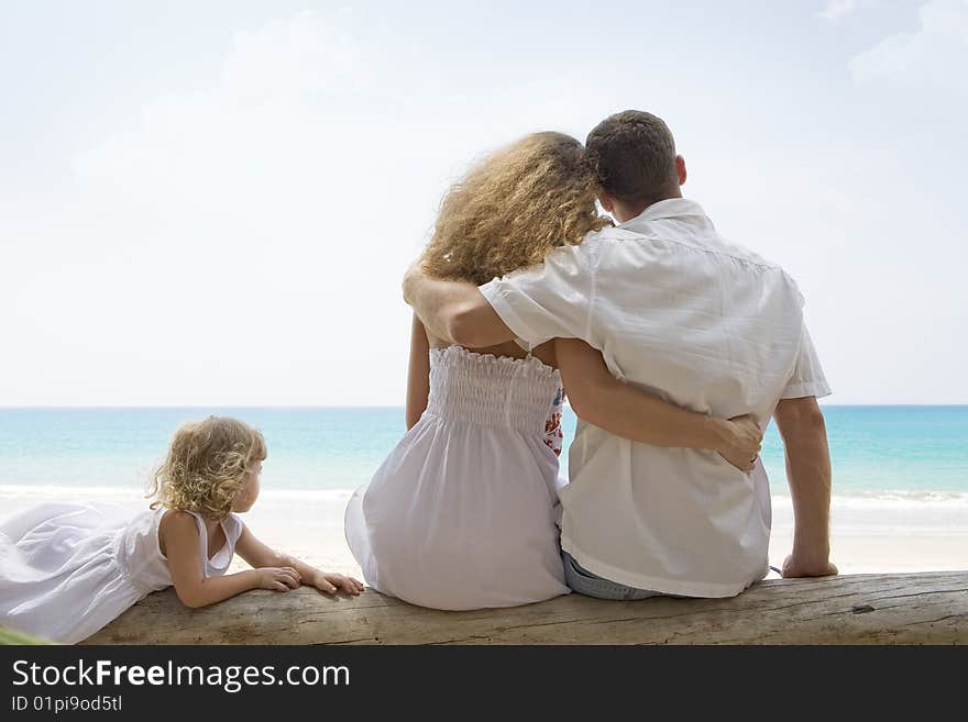 Portrait of young family having fun on the beach. Portrait of young family having fun on the beach