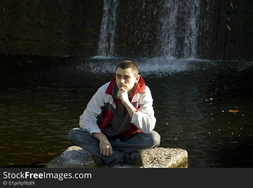 Man Sitting On A Stone