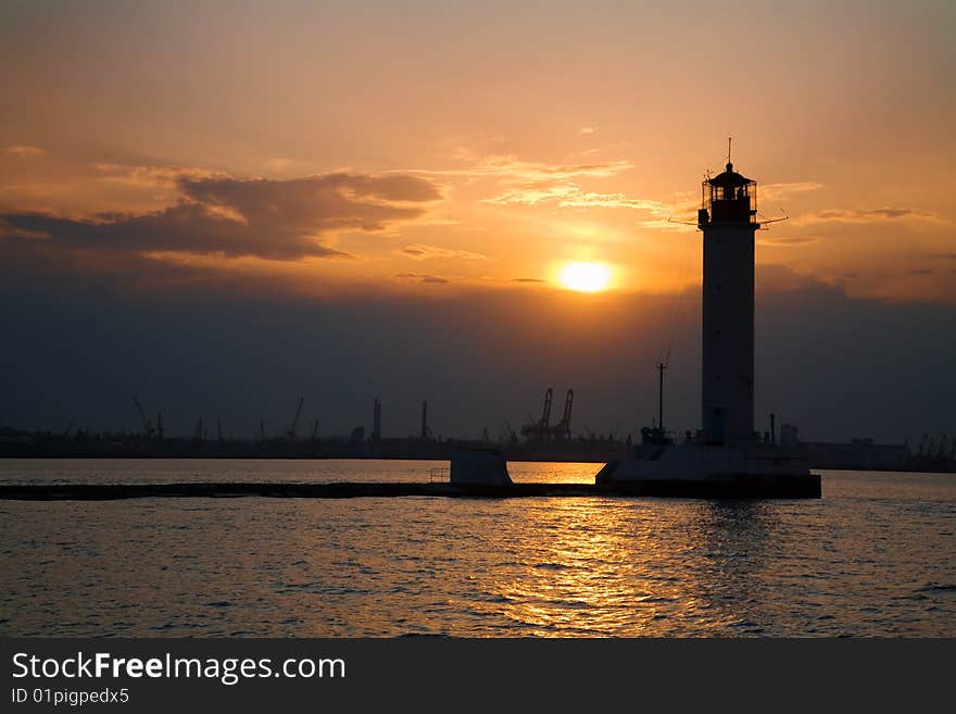 Silhouette of a lighthouse at dusk