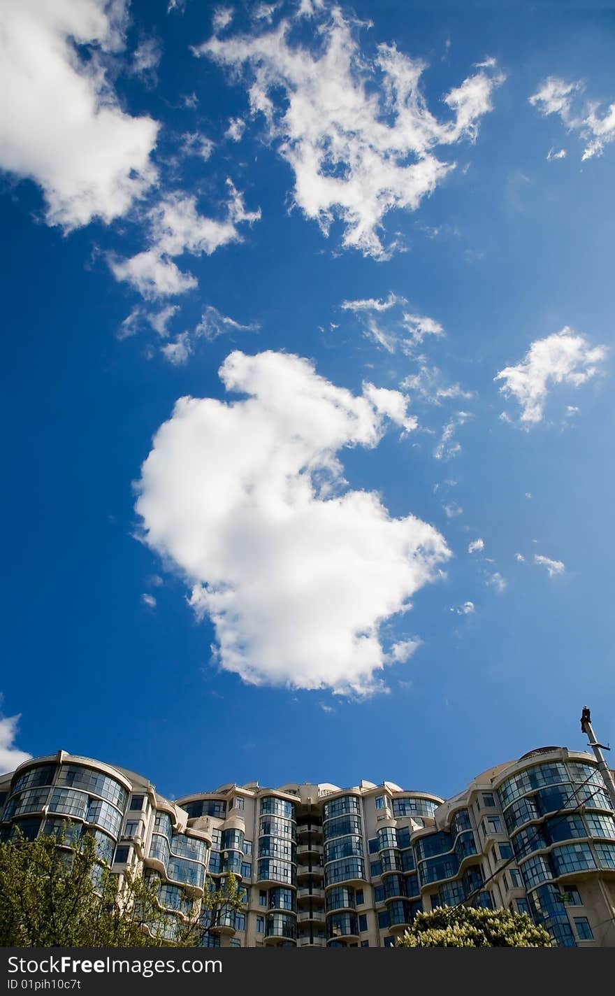 Generic modern building and cloudy sky