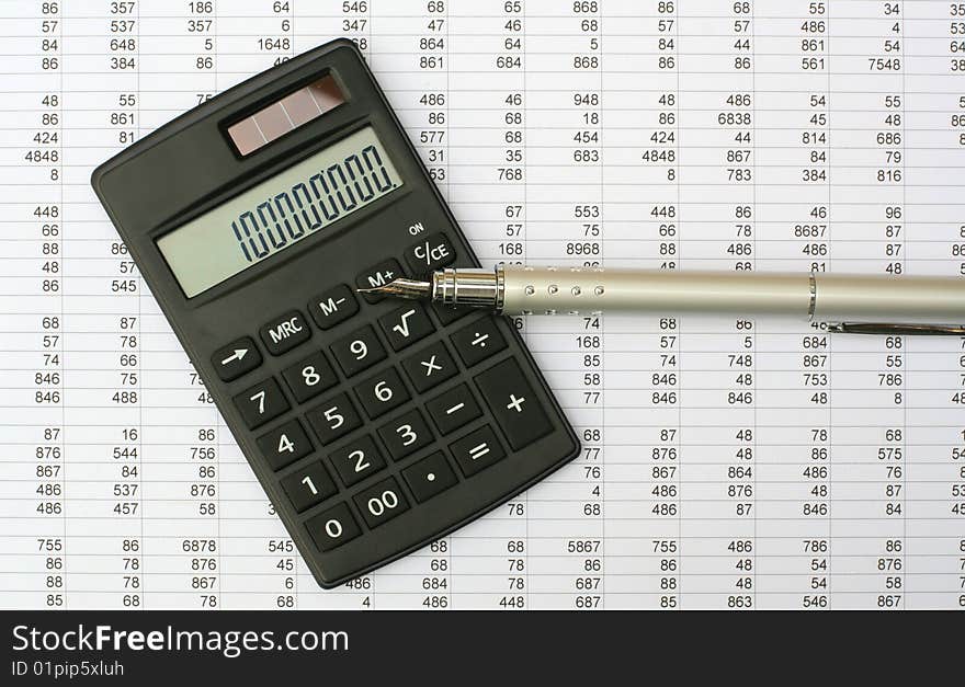 Calculator and pen on a white background. Calculator and pen on a white background