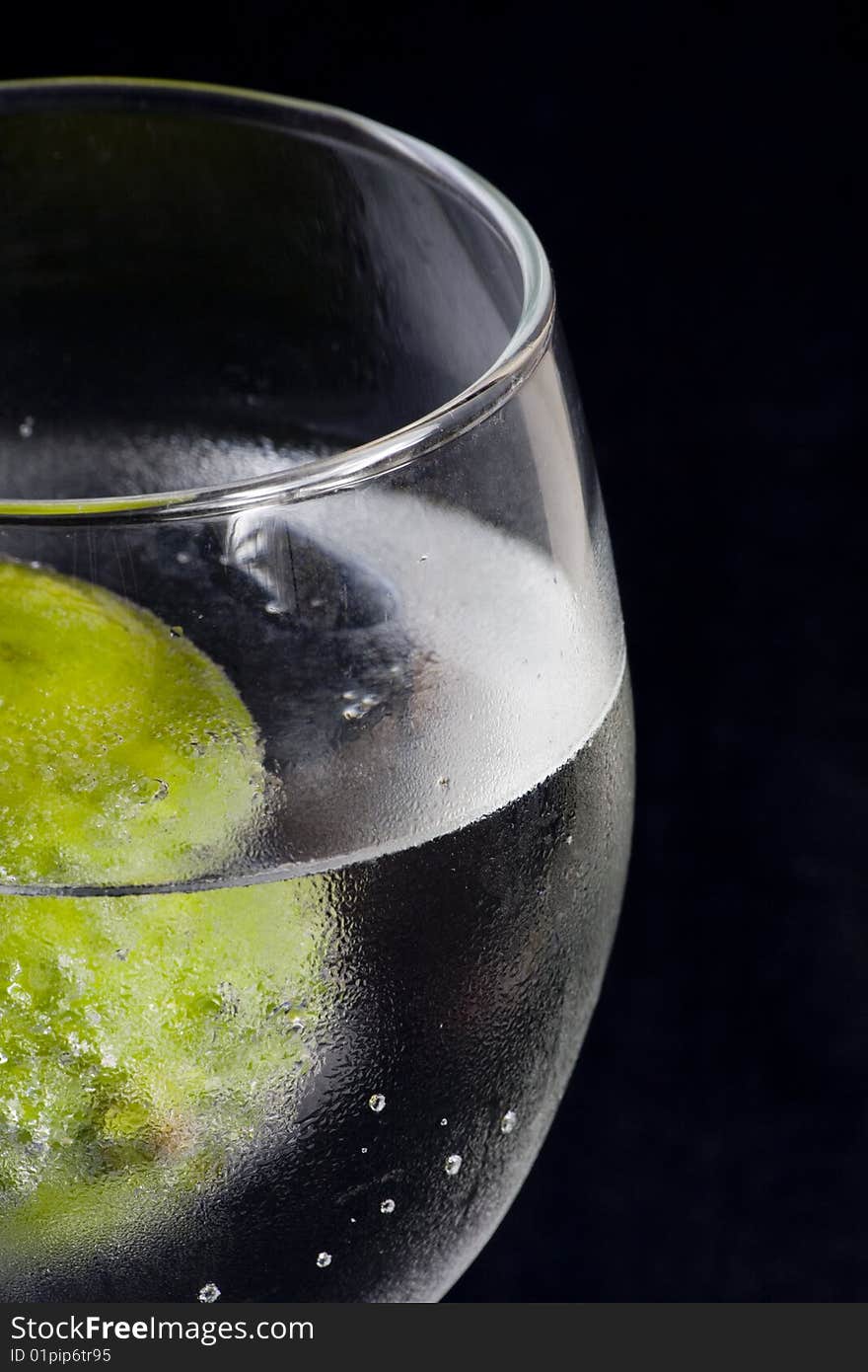 Closeup of a glass with sparkling water and lime. Closeup of a glass with sparkling water and lime