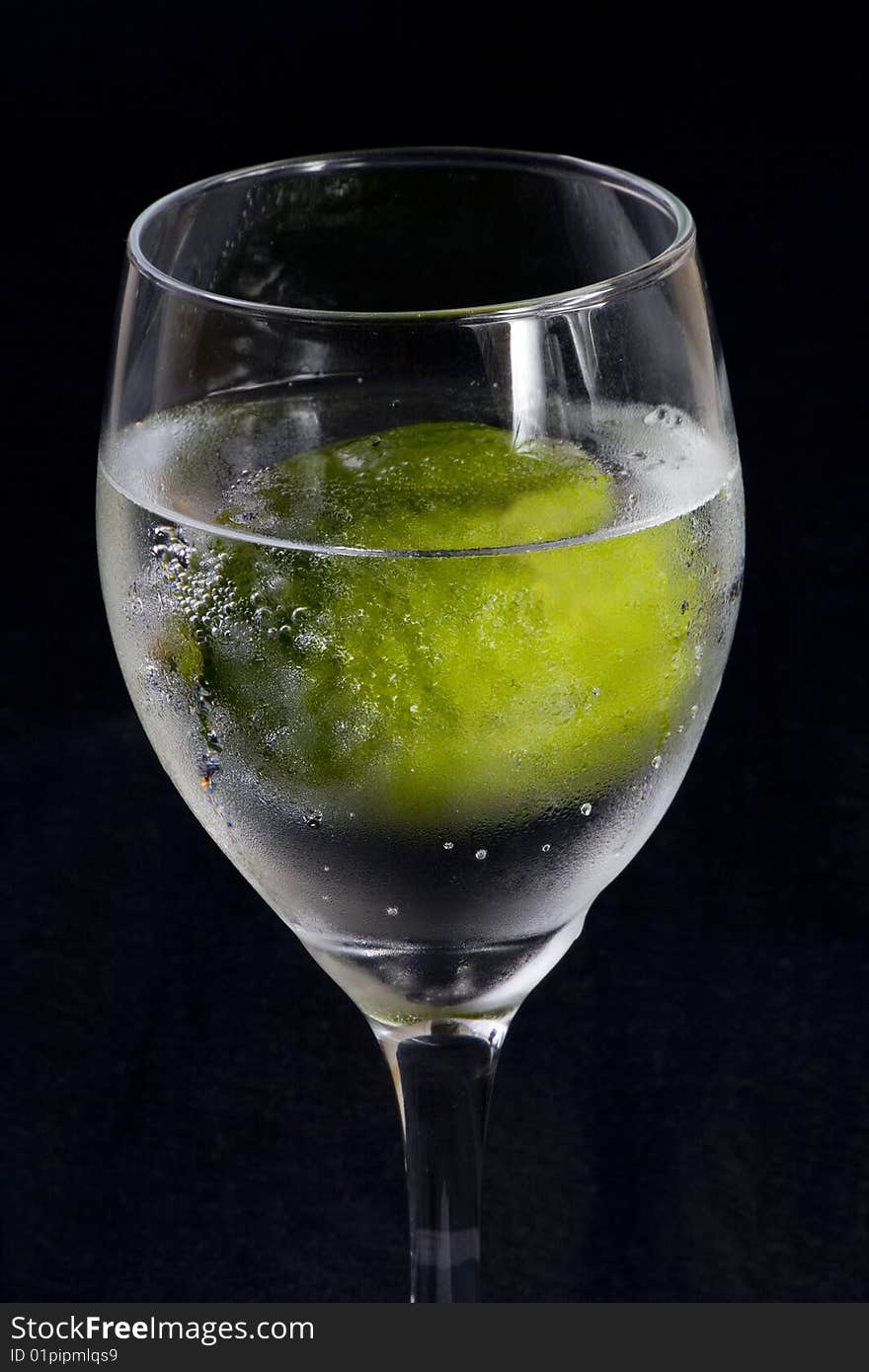 Closeup of a glass with sparkling water and lime. Closeup of a glass with sparkling water and lime