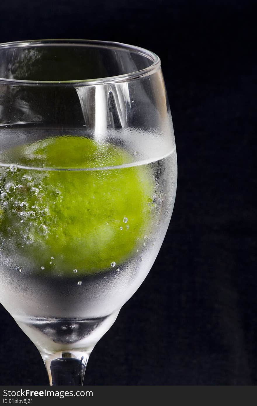 Closeup of a glass with sparkling water and lime. Closeup of a glass with sparkling water and lime