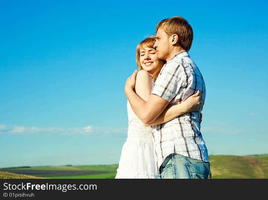 Happy young loving couple spending time outdoor in summertime