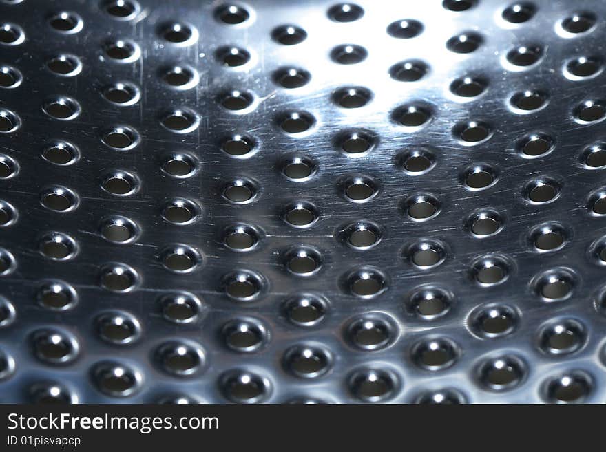 Abstract metal dark background with lot of small round holes standing in row. Abstract metal dark background with lot of small round holes standing in row