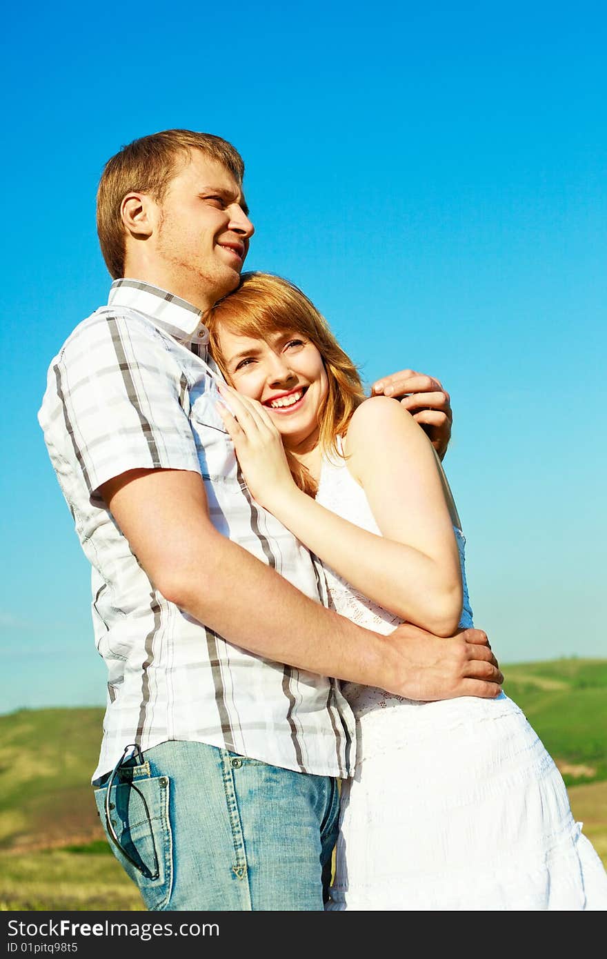 Happy young loving couple spending time outdoor in summertime