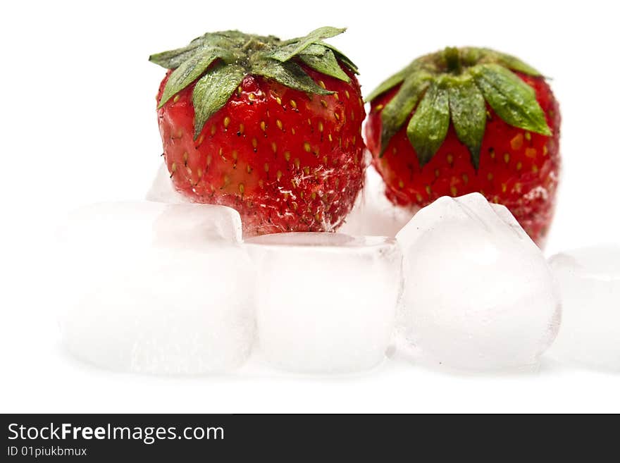 A fresh juicy strawberry is in ice. A fresh juicy strawberry is in ice