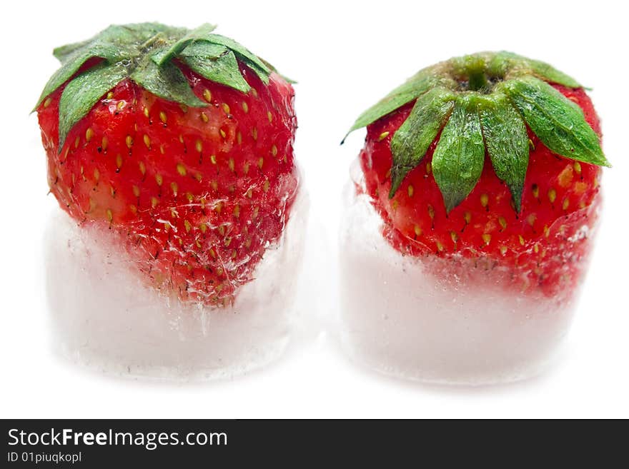 A fresh juicy strawberry is in ice. A fresh juicy strawberry is in ice