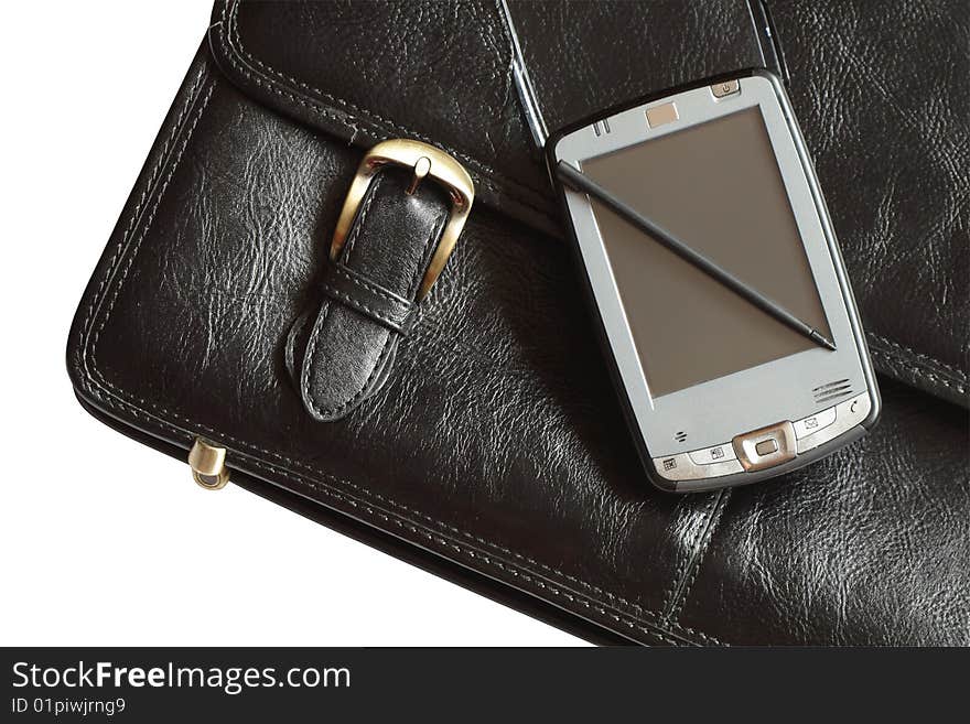 Pocket computer lying on black leather brief case isolated with clipping path